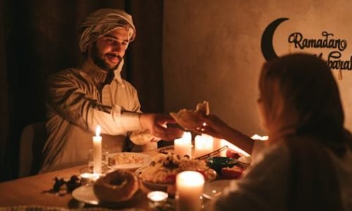 pexels-photo-7956570-7956570 A warm, candlelit dinner during Ramadan with a Muslim family sharing a meal.